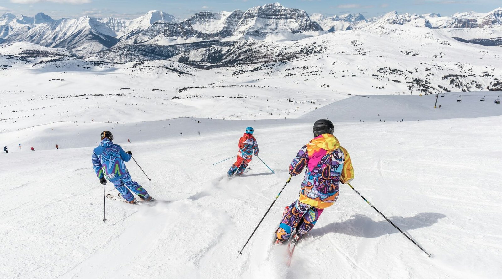Skiers on a sunny slope in the mountains