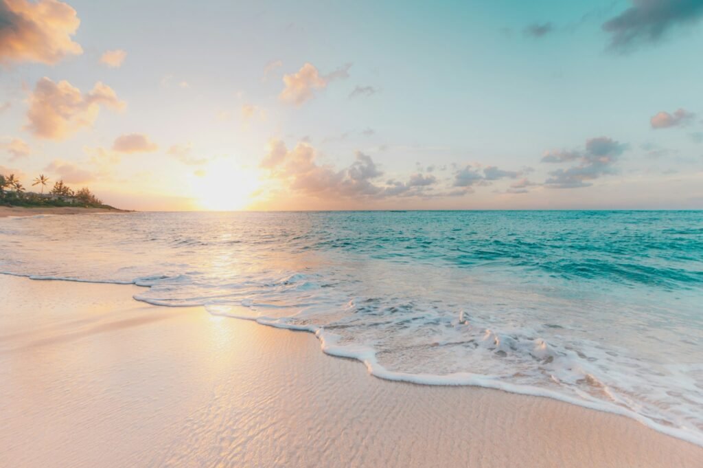 Calm tropical sea and beach at sunset