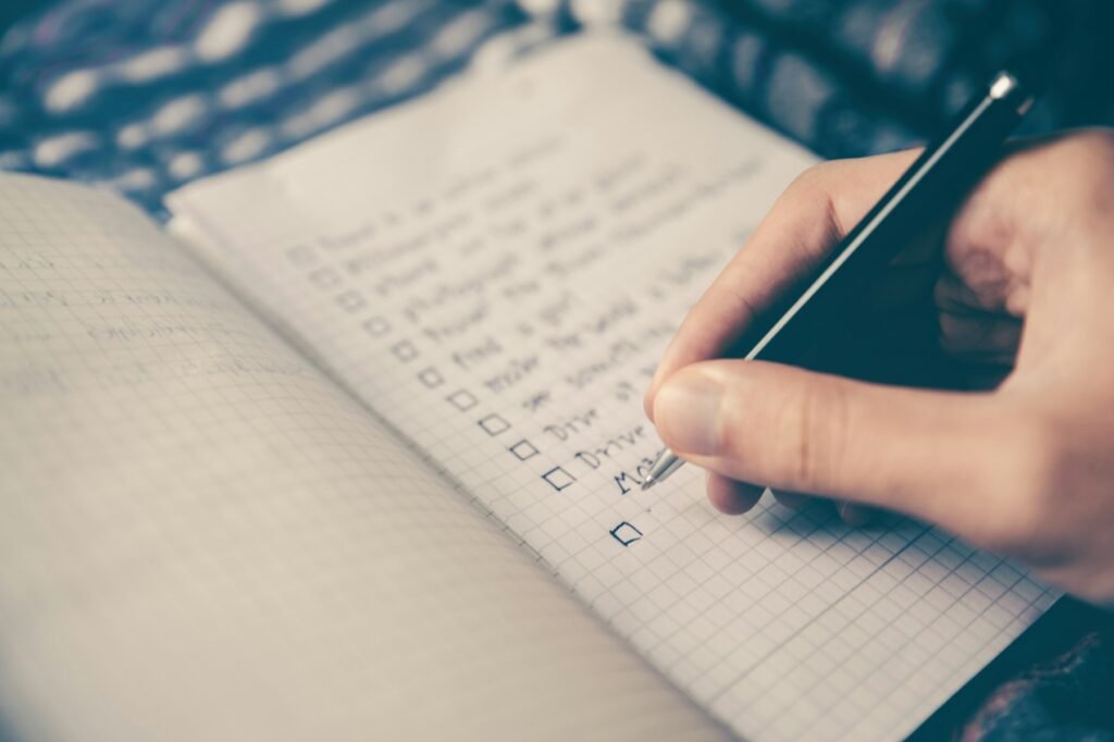 Writing a checklist in a notebook