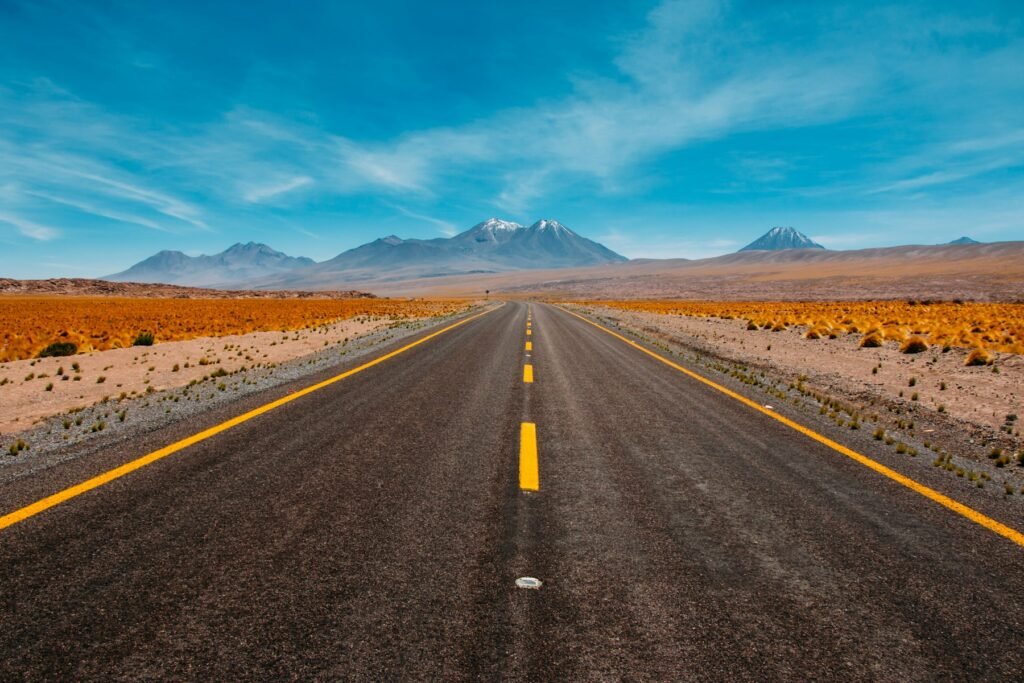Open highway stretching toward the mountains on a road trip